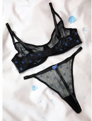 Back view of the black bow print mesh bra and thong set showing hook closure and bow detail