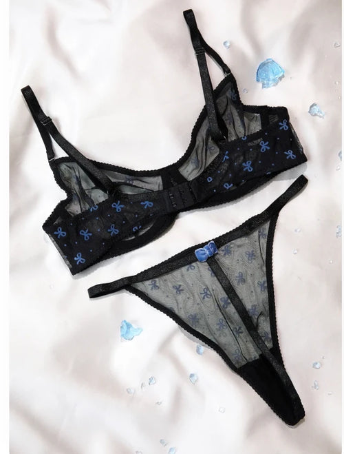 Back view of the black bow print mesh bra and thong set showing hook closure and bow detail